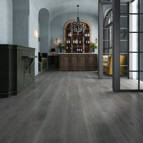Wide-plank gray hardwood floor in an open room with arched shelving