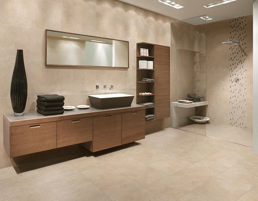 Beige stone-look tile floor and walls in a modern bathroom with a walk-in shower